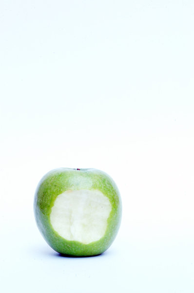 Green apple with bite in middl