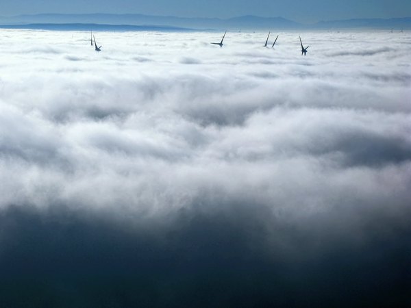 Windmills in floating clouds