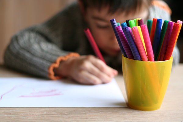 colour: little child making a drawing