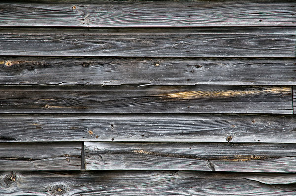 Wood wall: An old wall made of weathered wooden boards.