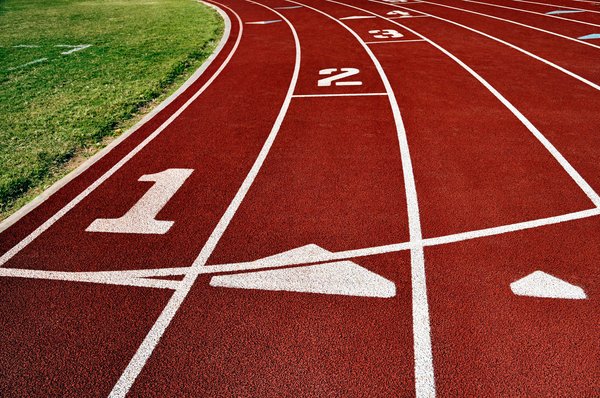 Track: Lanes of a running track at a school athletic field.