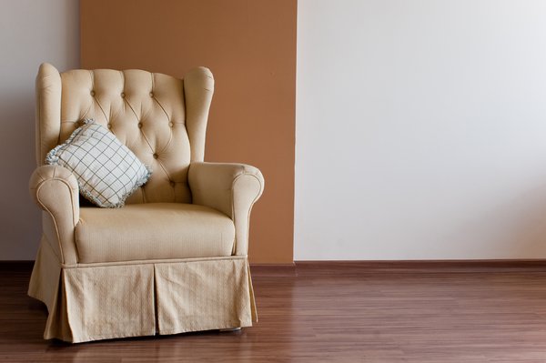 Chair and wall: Yellow chair in front of a brown wall
