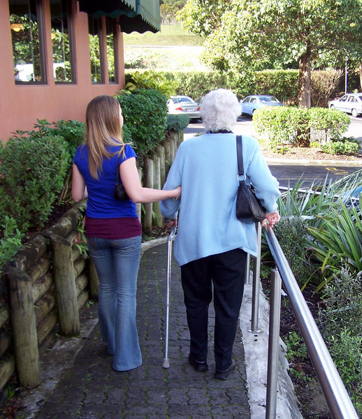 Helping the elderly: young person giving elderly lady a hand. Submitting this because of community/generation application.  