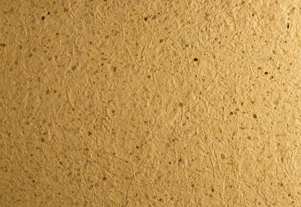 Handmade Paper: A texture of some handmade paper that is quite rough and has large glittery bits embedded in the layers of the fibers.