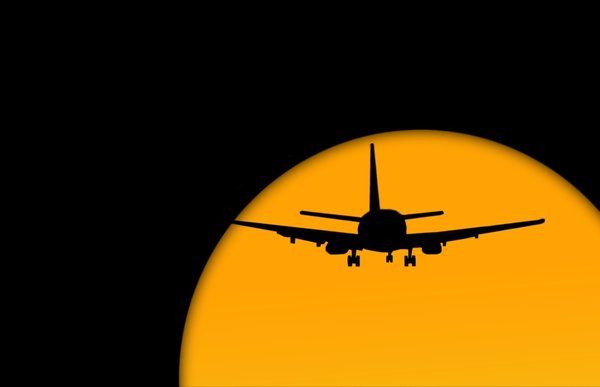 Jet Plane: Jet plane travel against a setting or rising sun