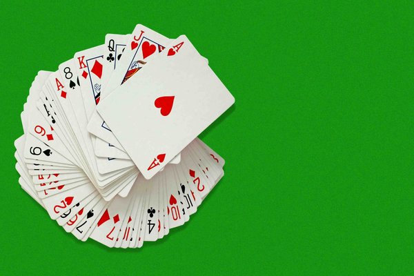 Card Pack: Pack of cards on green baize background with copyspace