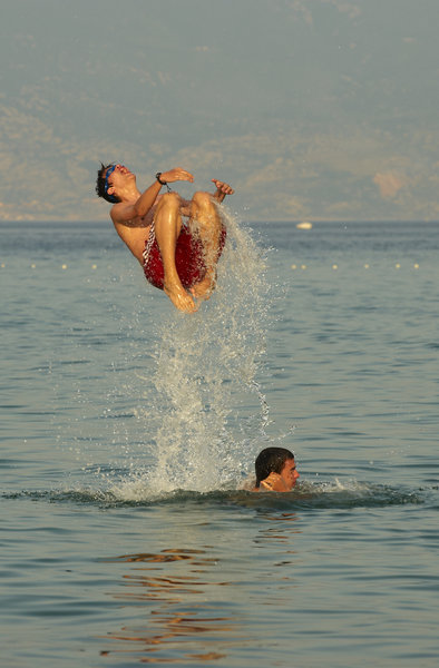 Young boys jumping in the sea