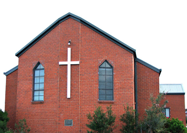 central cross: modern plain church building with central wall cross
