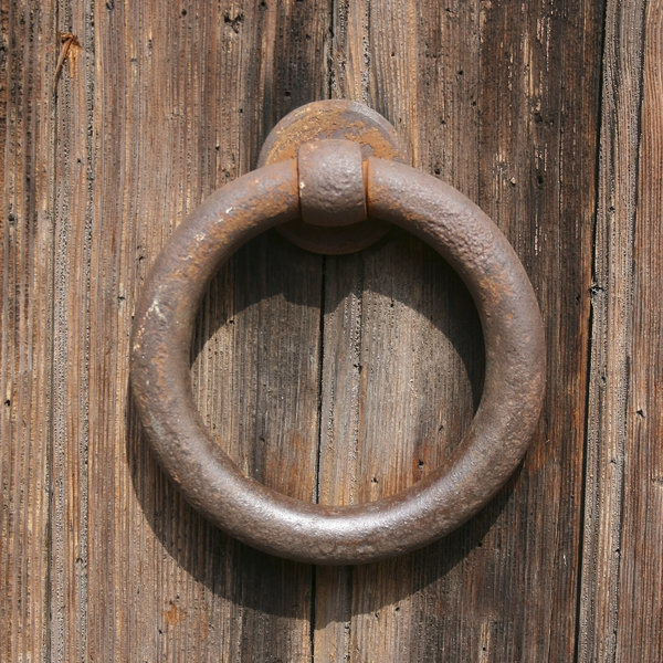 Door-handle: An iron ring door-handle on an old wooden door in Padua, Italy.