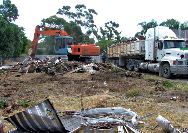 demolition job: suburban house demolition and removal with excavator and truck