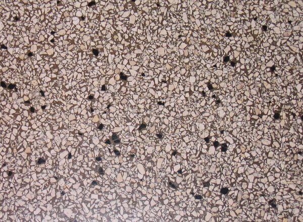 terrazzo texture: Terrazzo is a faux-marble flooring or countertopping material, made up of small chips of stone that are set hard in a binding material and then ground over until completely level.