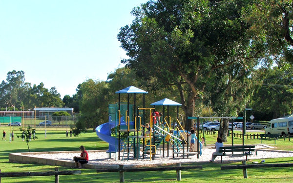 children's playground: children playing on playground equipment in local recreational area