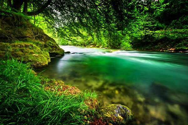 Emerald River: A natural River with clean and fresh, emerald green Water (Mangfall River, Bavaria, Germany)