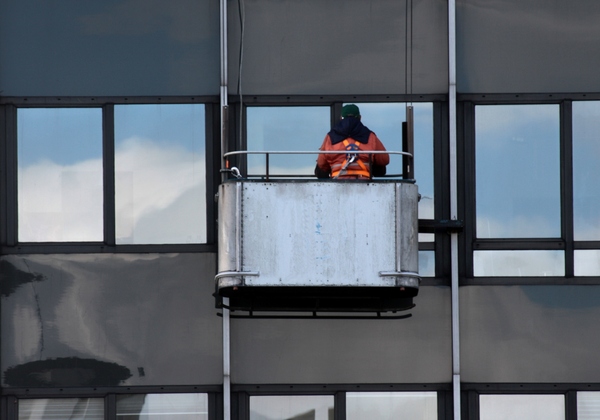 Window cleaning: Industrial window cleaner at work