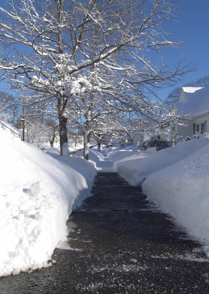 Snow Cleared Sidewalks: Snow cleared from asphalt sidewalks insures easy passage for pedestrians. New England - Winter Jan 2011