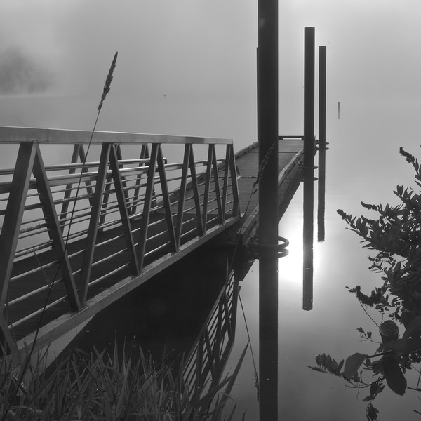 boat dock in fog: no description