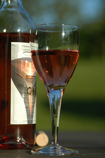 A glass of rose wine playing w: A glass of rose wine playing with the sun instead to be drinked !
