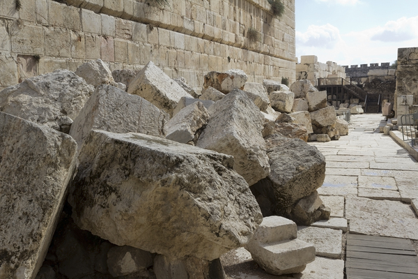 Jerusalem Temple stones: Huge stones hurled down by the Romans during the destruction of the Jewish Temple built by Herod in Jerusalem, Israel; hence about 2,000 years old. Smaller stones higher up in the wall are later renovations/alterations by other people groups. Photography 