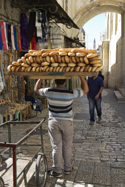 Delivering bread in Jerusalem: Delivering freshly baked bread in Old Jerusalem, Israel.