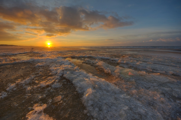 Sunset in the sea: Sunset in the sea woth ice in the coastline.