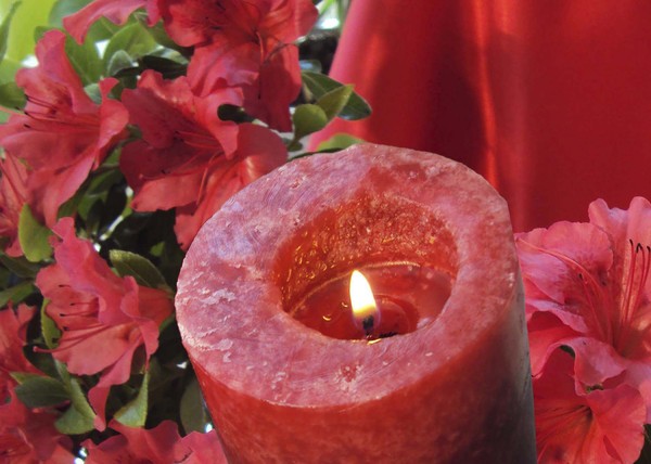 Red candle with red flowers