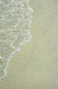 Sandy background: A small wave running up onto a sandy beach.NB: Credit to read 