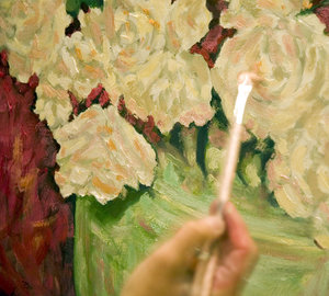 Painting in oils: An artist busy with a still life in oil paints.NB: Credit to read 