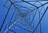 Electricity tower: Electricity tower seen from below, against blue sky