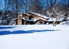 Chalet in Snow and Woods: Rustic house after a heavy snowfall