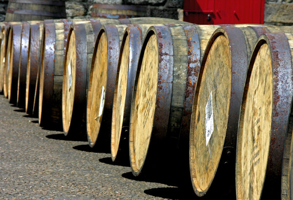Scotch Barrels: A row of Jack Daniels barrels at the Glen Morangie Distillery, Tain Scotland