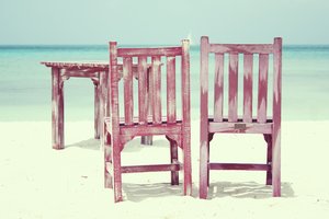 Beach chairs: Summer on tropical island (Aruba). Chairs and table on the beach with sea view.