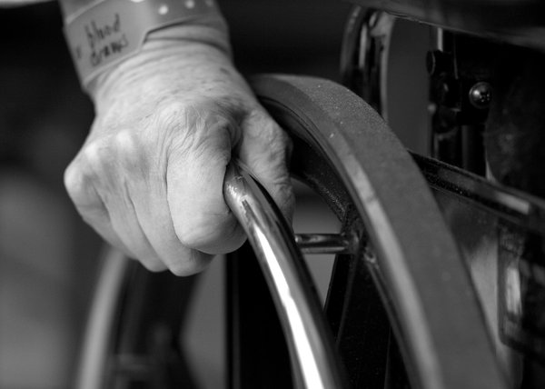 Wheelchair: Closeup of hand on wheelchair. 