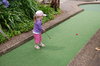Mini golf: Young girl playing mini golf