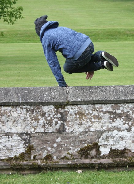The getaway?: Teen boy leaping a wall