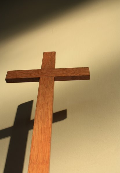 Cross with shadow: Close-up of small wooden cross, and its shadow on a wall