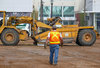 Back to work: A burley heavy equipment operator walks back to his machine.