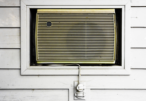 Air Conditioner: A single room air conditioner installed in a wall niche.