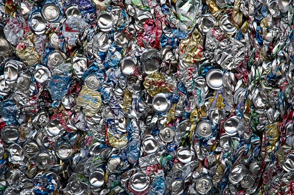 Recycling: Aluminum (aluminium) cans compressed into a large bale at a recycling facility.
