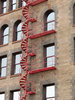 fire escape: a fire escape, red spiral stairs.