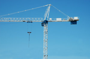 Construction Crane: Construction crane building a concrete skyscraper structure