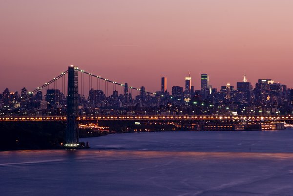 Manhattan at Sunset: George Washington Bridge and Manhattan Skyline during the golden hours from Palisades.