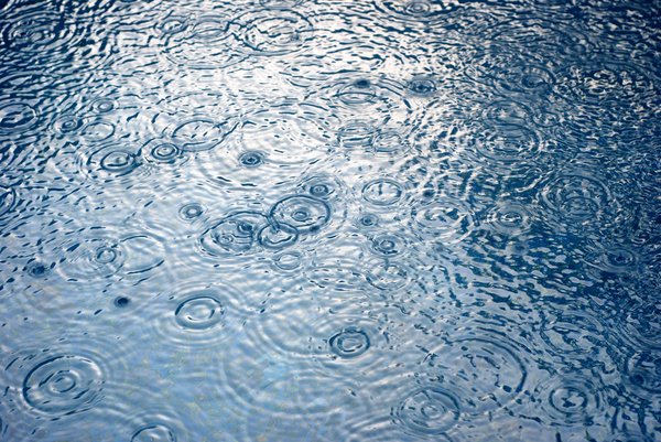 rain drop swim pool: heavy rain falls into swimming pool...
