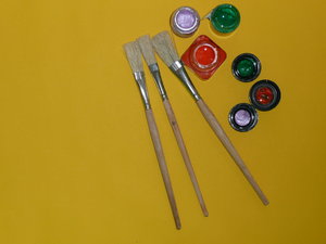 Painting: Paint brushes and paint pots on a sheet of paper