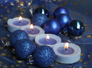 Blue Christmas Decoration: Baubles and candles on a sparkling blue background