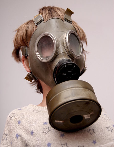Boy in the soviet gas mask  2: Mask worn over the face to protect the wearer from inhaling airborne pollutants and toxic materials
