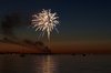 Fireworks on water: Fireworks on the coastline with lots of reflections and boats in the water