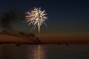 Fireworks on water: Fireworks on the coastline with lots of reflections and boats in the water