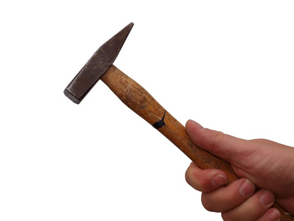 Handheld hammer: Hand holding a hammer