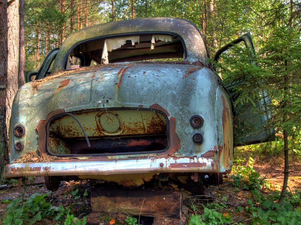 Disintegration - HDR: Old car lying in a forest. The picture is HDR using 5 images.