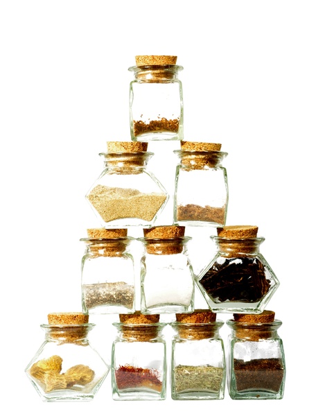 Spicy pyramid: Glasses with spices and herbs forming a pyramid